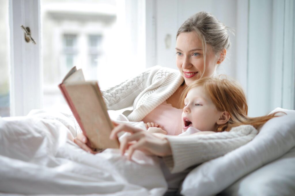 mom reading a book to  a child