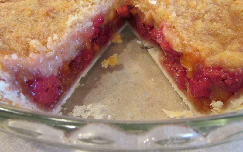Cherry Peach Pie with a slice out of it
